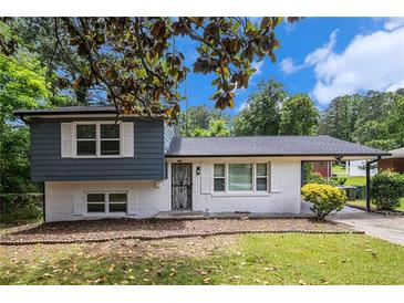 Charming two-story home boasts a white brick foundation and blue siding with a well-maintained lawn at 479 Charter Oak Sw Dr, Atlanta, GA 30331
