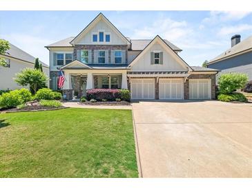 Charming two-story home with a manicured lawn, a three-car garage, and classic American design at 337 Spotted Ridge Cir, Woodstock, GA 30188