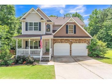 Charming two-story home with a well-maintained lawn, stone accents, and a welcoming front porch at 329 Kyles Cir, Hiram, GA 30141