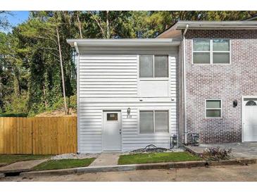Two-story townhome with white wood siding and a brick facade at 510 Northridge Crossing Dr, Sandy Springs, GA 30350