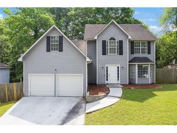 Charming two-story home with a two-car garage and a well-manicured lawn at 2907 Oakvale Falls Dr, Decatur, GA 30034