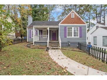 Charming home featuring grey siding, purple shutters, and a well-manicured front yard at 1686 Alvarado Sw Ter, Atlanta, GA 30310
