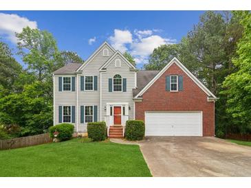 Charming two-story home with gray siding, brick accents, and a well-manicured front lawn at 111 Trellis Ct, Acworth, GA 30101