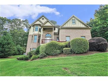 Charming two-story brick home with manicured landscaping and a welcoming front porch at 3641 Mountain Cove Rd, Snellville, GA 30039