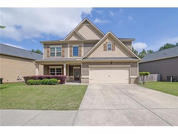 Charming two-story home with manicured lawn, inviting entryway, and neutral exterior paint at 4251 Haywater Cv, Buford, GA 30519