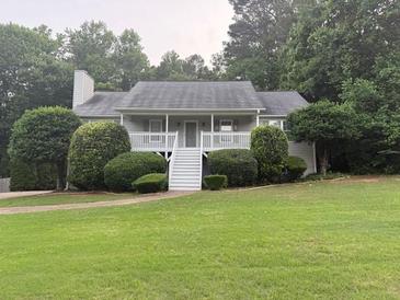 Charming single-story home with a welcoming front porch and well-manicured lawn at 6275 Cheatham Lake Nw Dr, Acworth, GA 30101