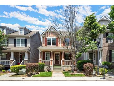 Charming two-story townhome with inviting front porch and well-maintained landscaping at 1744 Habershal Nw Dr, Atlanta, GA 30318