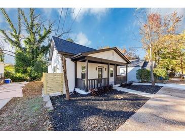 Charming home boasts a covered front porch and freshly mulched landscaping in a tranquil setting at 923 Smith Sw St, Atlanta, GA 30310