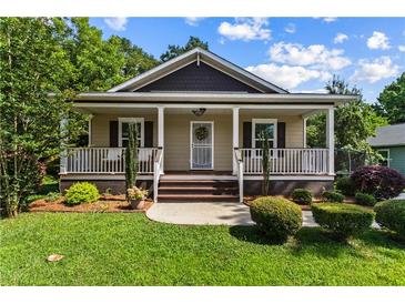 Charming single Gathering home with a cozy front porch and well-manicured lawn at 1751 Thomasville Se Dr, Atlanta, GA 30315