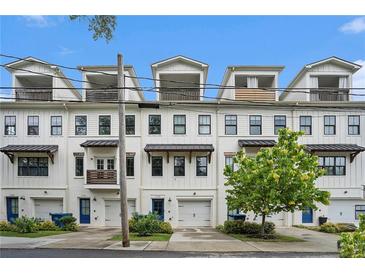 Modern townhome row boasts clean white facades, upper-level decks, and convenient garage access at 1192 Wylie Se St # 429, Atlanta, GA 30316