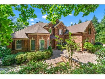 Stunning brick home with lush landscaping and a paver walkway at 5765 Riley Rd, Cumming, GA 30028