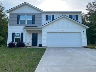 Charming two-story home with a large two car garage and a well maintained lawn at 30 Sloane Ct, Covington, GA 30016