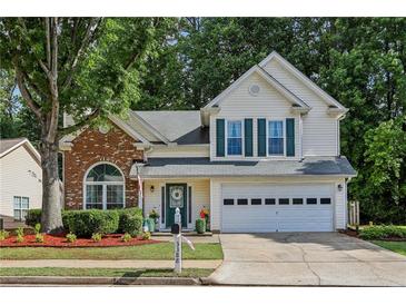 Charming two-story home with a well-manicured lawn and a two-car garage in a great neighborhood at 3388 Washington Cmns Nw Ave, Kennesaw, GA 30144
