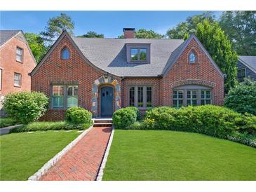 Charming brick home with manicured lawn, lush greenery, and inviting entryway; a beautiful suburban residence at 1146 Cumberland Ne Rd, Atlanta, GA 30306