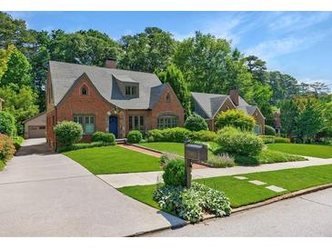 Charming brick home featuring lush lawn, manicured landscaping, and a quaint mailbox at 1146 Cumberland Ne Rd, Atlanta, GA 30306
