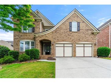 Charming brick home with a well-manicured lawn and a two-car garage at 4677 Prater Se Way, Smyrna, GA 30080