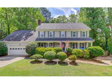 Charming two-story home with well-manicured landscaping and a classic colonial facade at 905 Foxfire Dr, Lawrenceville, GA 30044