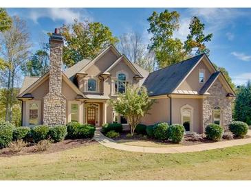 Charming two-story home featuring stone accents, lush landscaping, and a welcoming entrance at 237 Libby Ln, Canton, GA 30115