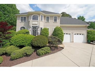 Charming two-story home with manicured landscaping and attached two-car garage at 5617 Asheforde Ln, Marietta, GA 30068