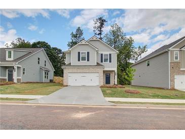 Charming two-story home featuring a brick-accented garage and complementary light-gray siding at 19 Camellia Dr, Fairburn, GA 30213