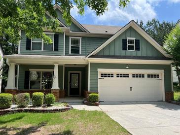 Charming two-story home with green siding, white trim, a well-maintained lawn, and a two-car garage at 519 Granite Nw Ct, Lawrenceville, GA 30044