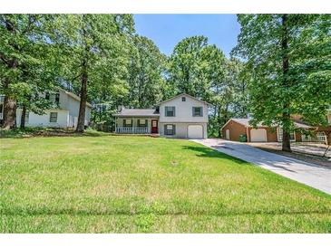 Charming home featuring a well-maintained lawn, mature trees, and inviting curb appeal at 1934 Patton Pl, Lithonia, GA 30058