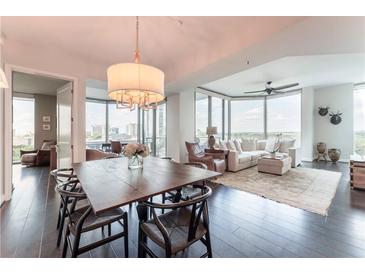 Bright living room with hardwood floors, modern furnishings, and city views from large windows at 2795 Peachtree Ne Rd # 1009, Atlanta, GA 30305