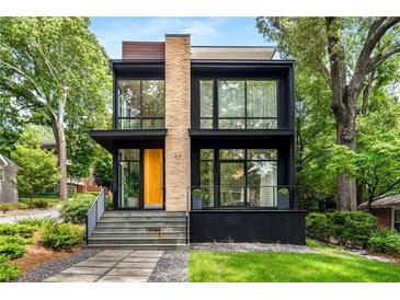 Modern two-story home featuring large windows, stone accents, and manicured landscaping at 819 Belgrade Ne Ave, Atlanta, GA 30306