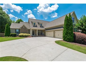 Charming home featuring lush landscaping, a wide driveway, and a welcoming front porch at 200 Glenview Ct, Woodstock, GA 30188