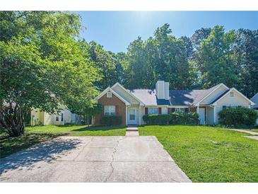 Charming single story home with brick and vinyl siding, manicured lawn, and a long driveway at 1249 Scripps Sw Ct, Marietta, GA 30008