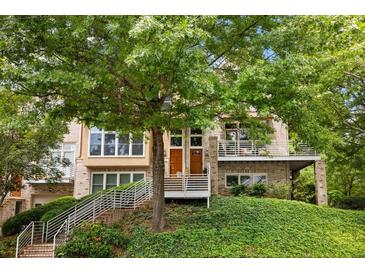 Charming townhouse with well-manicured lawn and two entrances with iron handrails leading up to the front doors at 1354 Fernwood Ne Cir, Brookhaven, GA 30319