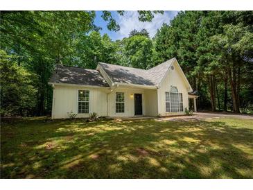 Charming one-story home with a well-maintained lawn and mature trees surrounding the property at 5340 Young Deer Dr, Cumming, GA 30041