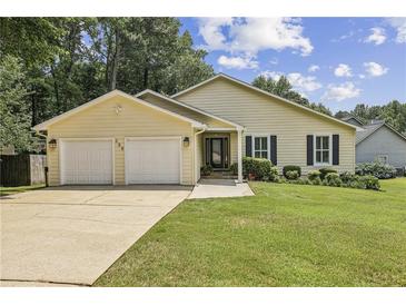 Charming single-story home with a well-manicured lawn, attached two-car garage, and inviting front entrance at 255 Broken Lance Pl, Johns Creek, GA 30022