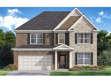 Charming two-story home featuring a brick and stone facade with an attached two-car garage at 7171 Linden Dr, South Fulton, GA 30349