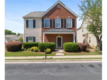 Charming two-story home with brick and vinyl siding, black shutters, and well-maintained landscaping at 3223 Tallon Sw Ln, Atlanta, GA 30311