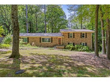 Charming brick home with a well-manicured front yard surrounded by mature trees at 3362 Northbrook Dr, Atlanta, GA 30340