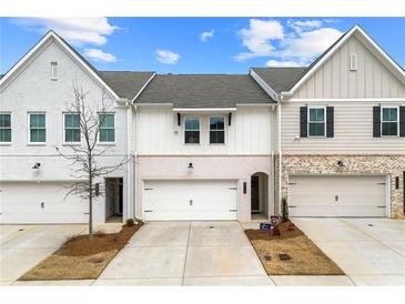 Charming townhouse showcasing a brick facade, attached garage, and well-manicured lawn at 3610 Silvery Way, Powder Springs, GA 30127