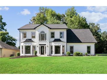 A charming home featuring a manicured lawn and striking black and white color scheme at 4168 Arapaho Dr, Powder Springs, GA 30127