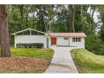 Charming, ranch-style home with brick accents, mature trees, and a well-manicured lawn at 4376 Riverwood Cir, Decatur, GA 30035