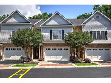 Charming townhome with brick facade, manicured landscaping, and attached garages at 5492 Glenridge Dr # 536, Atlanta, GA 30342