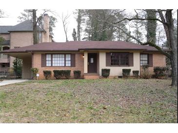 Charming single-story brick home with a cozy covered carport, well-maintained landscaping, and a welcoming entrance at 1253 Dunwoody Ne Ln, Brookhaven, GA 30319