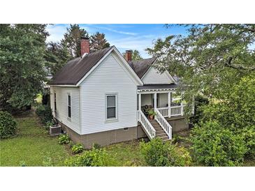 Charming exterior view of home, showing the front porch and well-maintained landscaping at 2 N Broad St, Porterdale, GA 30070