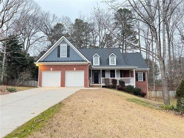 Charming brick home with a two-car garage and welcoming front porch; perfect for suburban living at 6745 Fairfield Trce, Suwanee, GA 30024