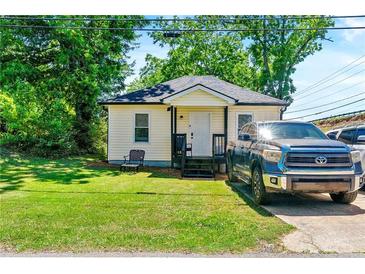 Charming single story home with a well-maintained lawn and tidy landscaping, a relaxing place to call home at 1357 Railroad Ave, Sugar Hill, GA 30518