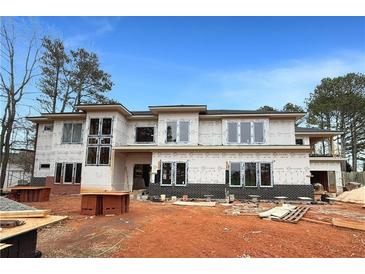 New construction home featuring a contemporary design with large windows and a brick foundation, set in a construction site at 2709 Collins Hill Rd, Lawrenceville, GA 30043
