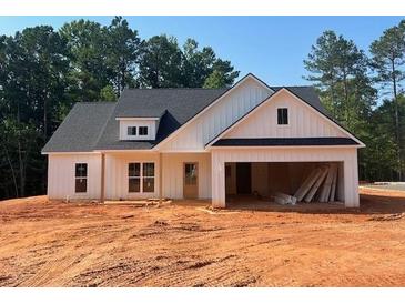 Charming single-story home with white siding and a spacious two-car garage at 610 Presley Farm Pkwy, Rockmart, GA 30153