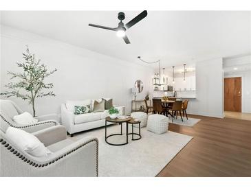 Bright living room featuring hardwood floors, a ceiling fan, and contemporary furnishings at 273 12Th Ne St # 114, Atlanta, GA 30309