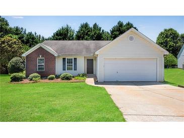 Charming single-story home with a brick accent, manicured lawn, and attached two-car garage at 424 Yellow River Walk, Lawrenceville, GA 30043