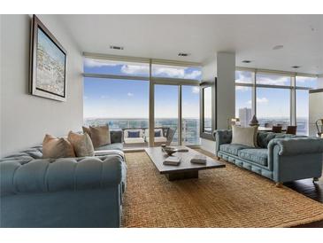 Bright living room with floor to ceiling windows and an outdoor terrace to enjoy the city views at 45 Ivan Allen Jr Blvd # 2203, Atlanta, GA 30308