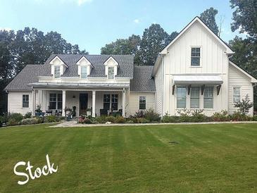 Charming farmhouse exterior with a welcoming front porch and well-manicured lawn and appealing architectural details at 2226 Upper Burris Rd, Canton, GA 30114